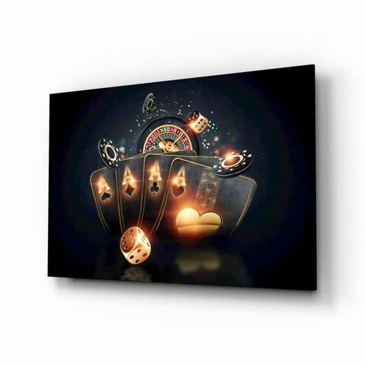 Glass wall art displaying glowing golden playing cards, roulette wheel, dice, and poker chips on dark background, angled perspective view.