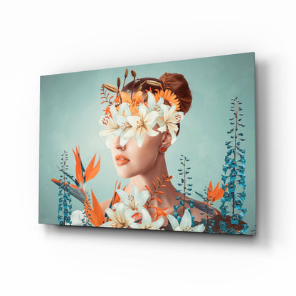 Woman's profile with white and orange lilies obscuring face against turquoise background on glass canvas, displayed at angle.