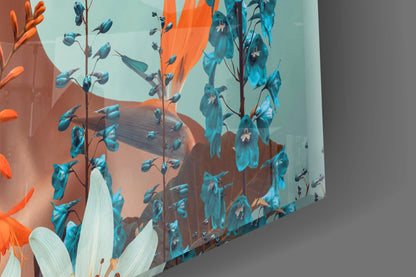 Abstract glass wall art featuring blue floral stems and orange-red blooms against a light blue and brown gradient background, angled perspective view.