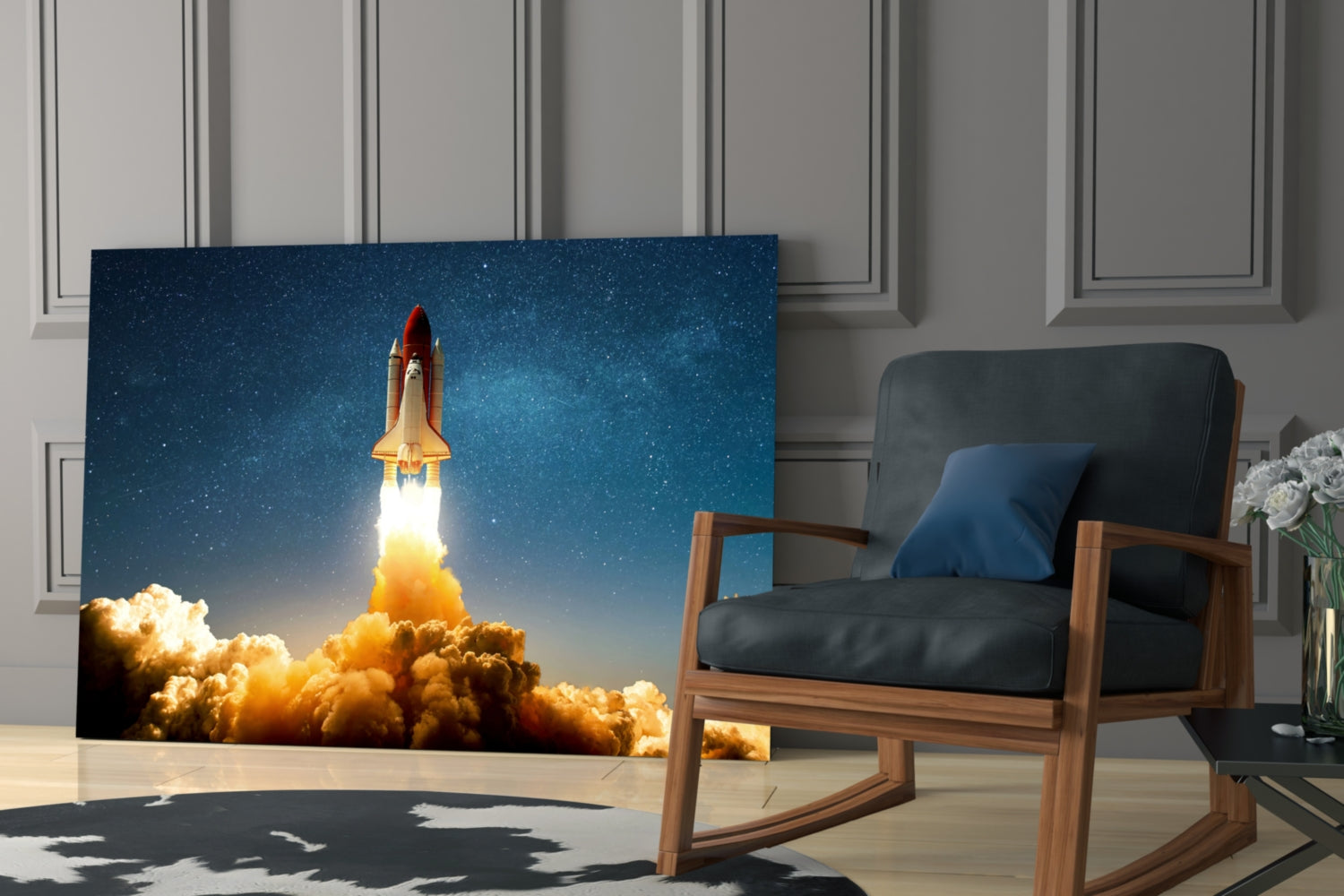 Glass wall art displaying a space shuttle launching through orange clouds against a starry blue sky, installed in a modern living room beside a wooden chair.
