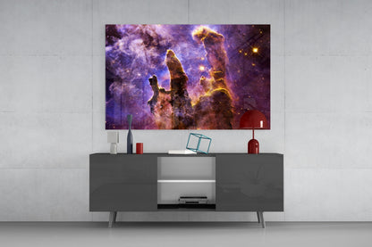 Purple and gold nebula glass art panel mounted above gray media console in modern living room setting.