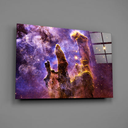 Three-dimensional glass wall art displaying the Pillars of Creation nebula with purple, gold, and brown cosmic clouds against a gray background.
