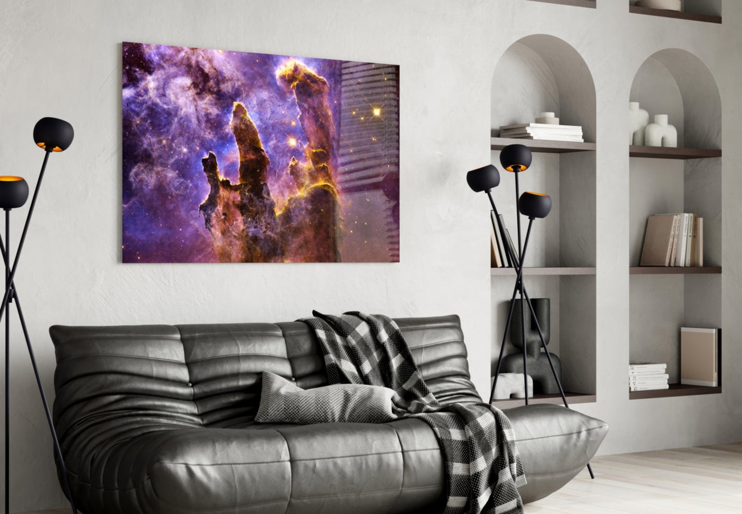 Space Lilac glass wall art displaying purple and gold nebula pillars hangs above a black leather sofa in a modern living room.