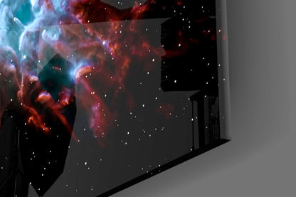 Red and blue nebula glass wall art installed in corner of modern room, displaying cosmic cloud patterns with stars.