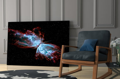 Space Red Glass Wall Art displaying a red and blue nebula against black starfield, installed in a modern living room with wooden chair.