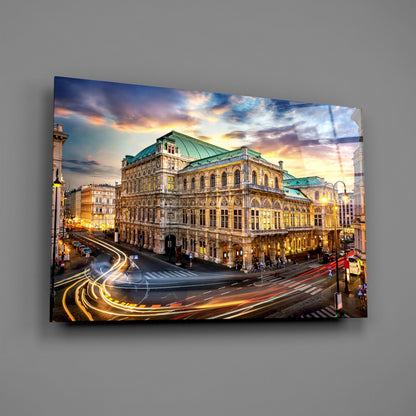 Vienna State Opera building illuminated at dusk with light trails from passing vehicles on glass wall art.