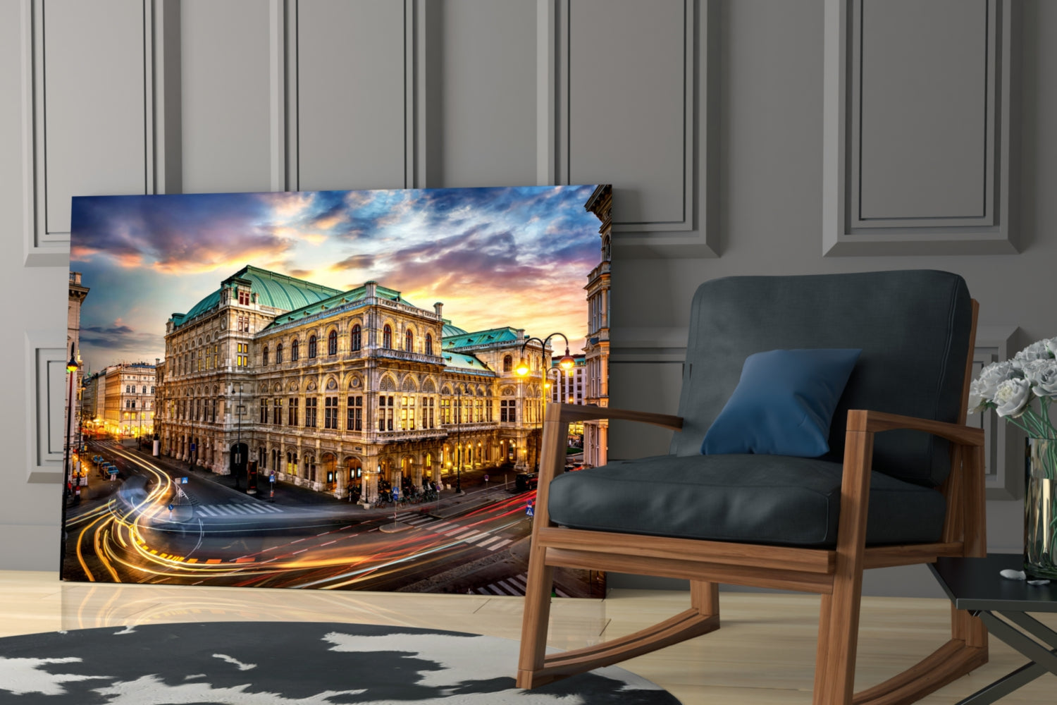 Vienna State Opera glass wall art displayed on floor leaning against wall beside wooden rocking chair in modern interior.