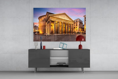 Pantheon Glass Wall Art mounted above gray media console, displaying illuminated ancient Roman temple at dusk with golden columns and pink sky.