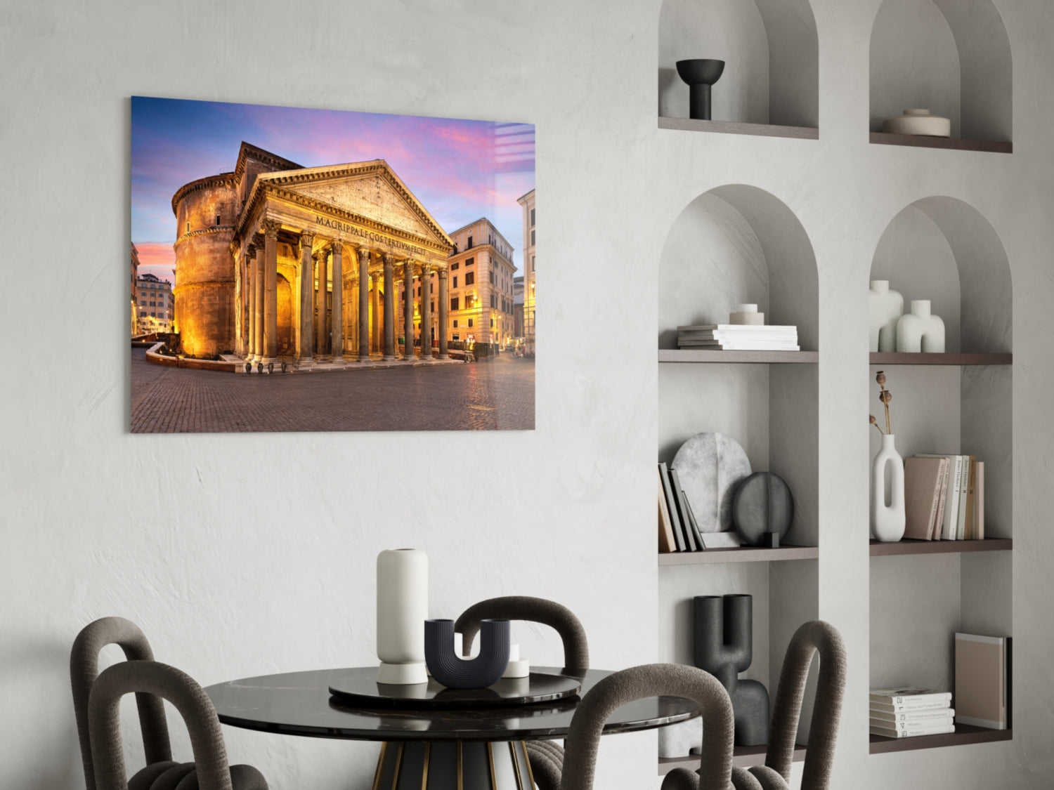 Pantheon glass wall art displaying illuminated Roman temple at twilight, hung above black dining table in modern interior.