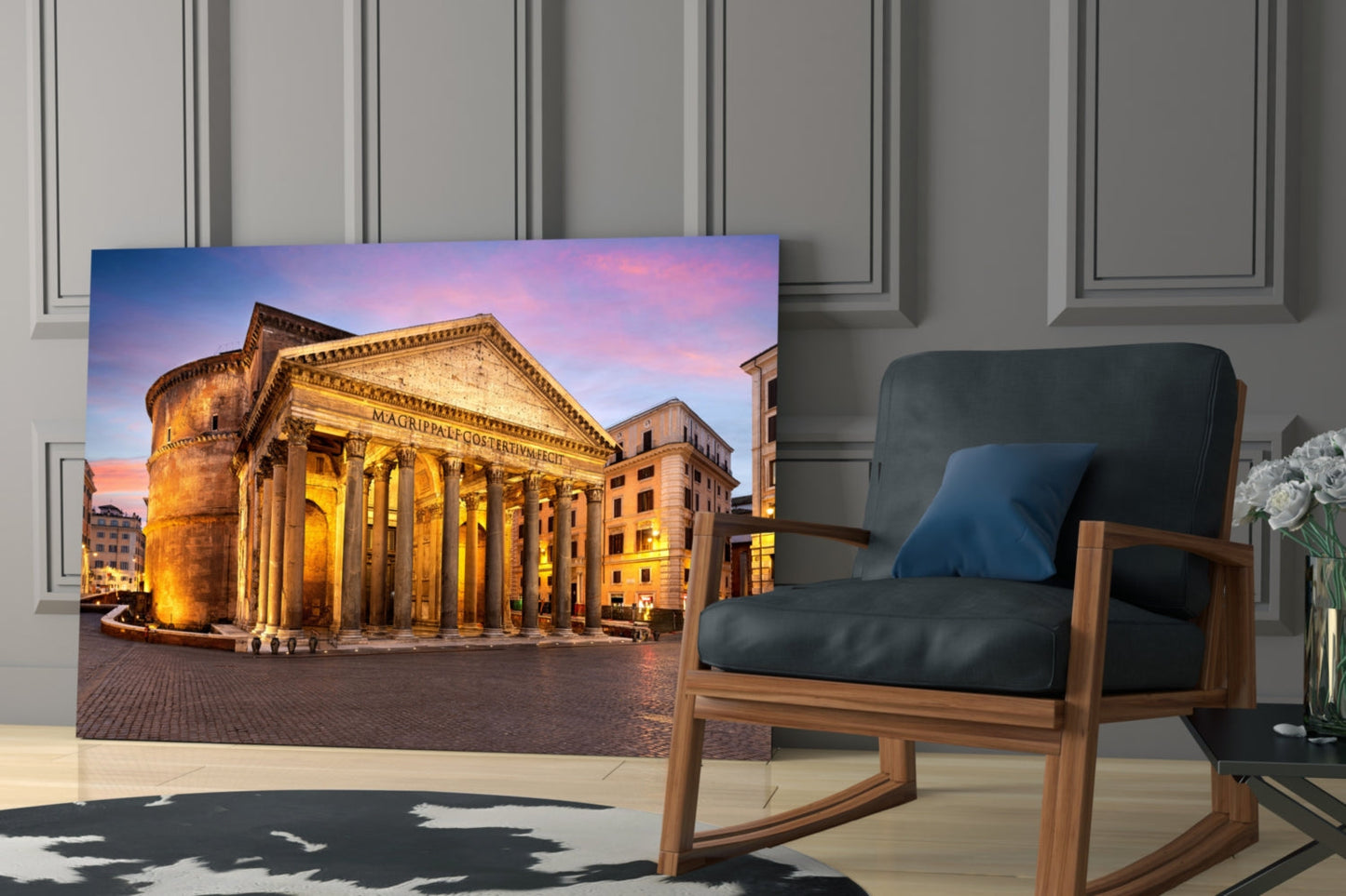 Pantheon glass wall art displaying illuminated Roman temple at twilight, hung in modern living room beside wooden chair.