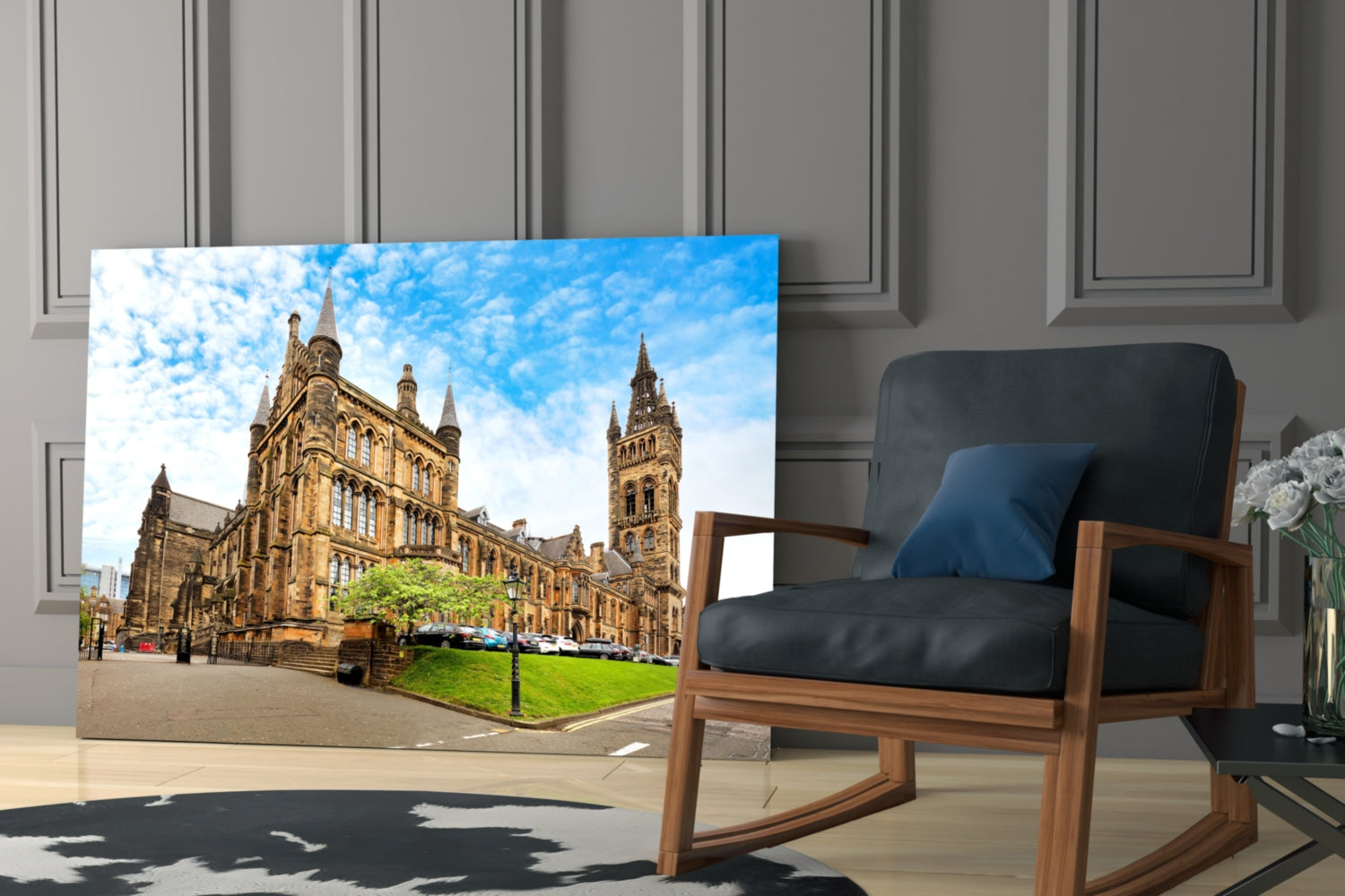 University of Glasgow glass wall art displaying golden sandstone buildings with blue sky, displayed in modern living room beside wooden chair.