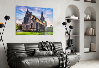 Glasgow Cathedral glass wall art mounted above a black leather sofa in a modern living room with white shelving.
