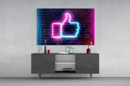 Neon thumbs-up sign in pink and blue displayed on wall above gray media console in modern living room interior.