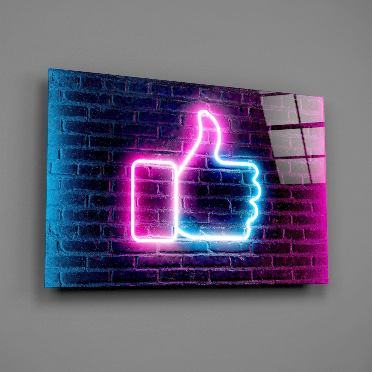 Neon thumbs up sign glowing pink and blue against dark brick wall on glass panel, angled perspective.