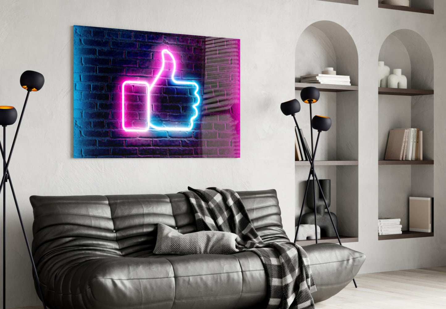 Neon thumbs-up sign in pink and blue glowing above a gray leather sofa in a modern living room.