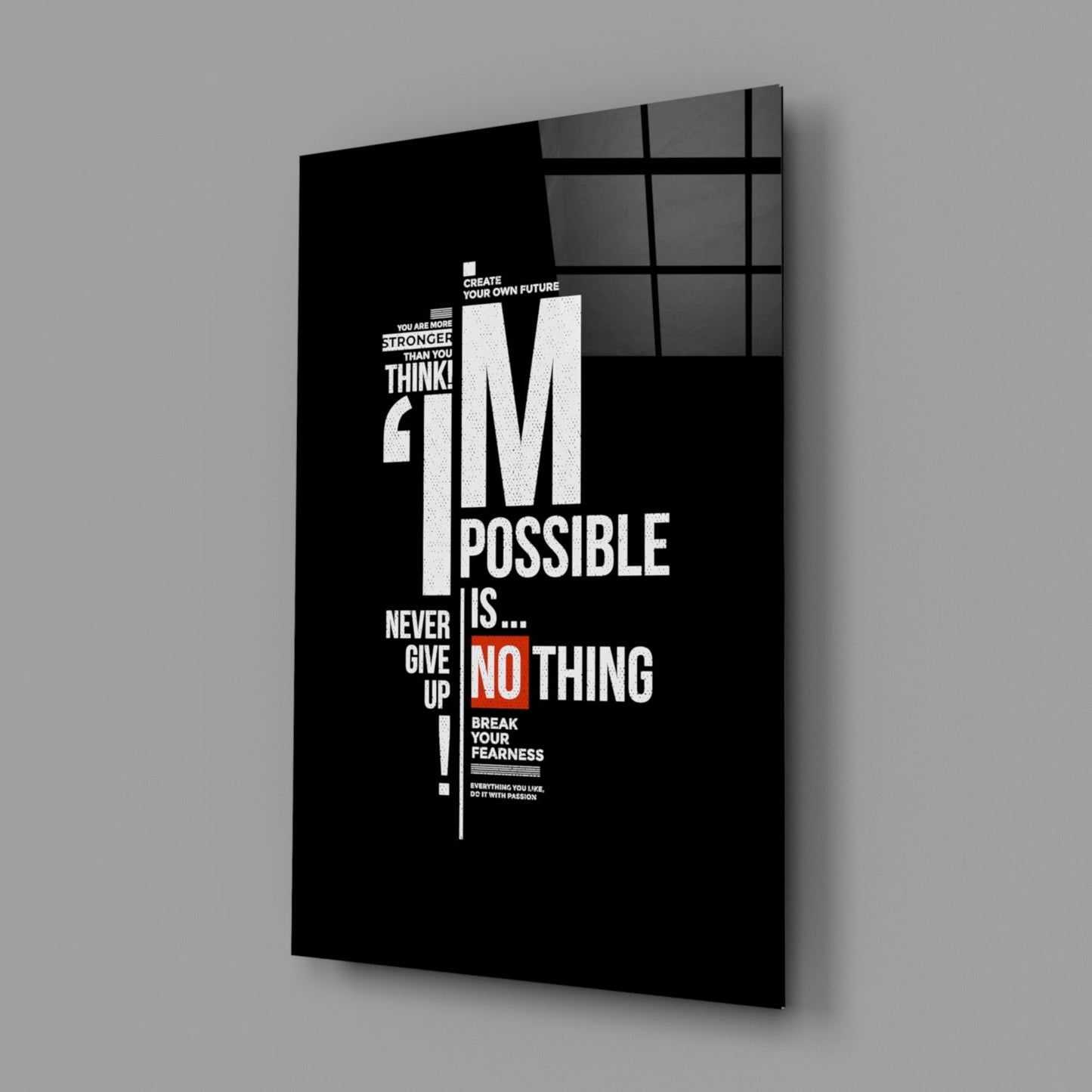 Black glass motivational wall art panel displaying white and red text with inspirational quotes, shown at an angle against gray background.