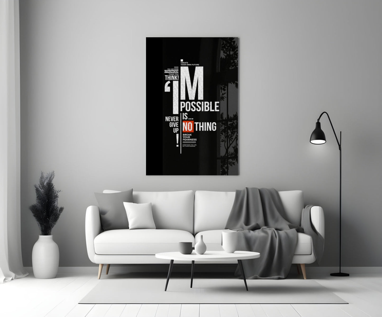 Black motivational glass wall art with white and red text reading "I'm Possible is Nothing" displayed above a white sofa in a minimalist living room.
