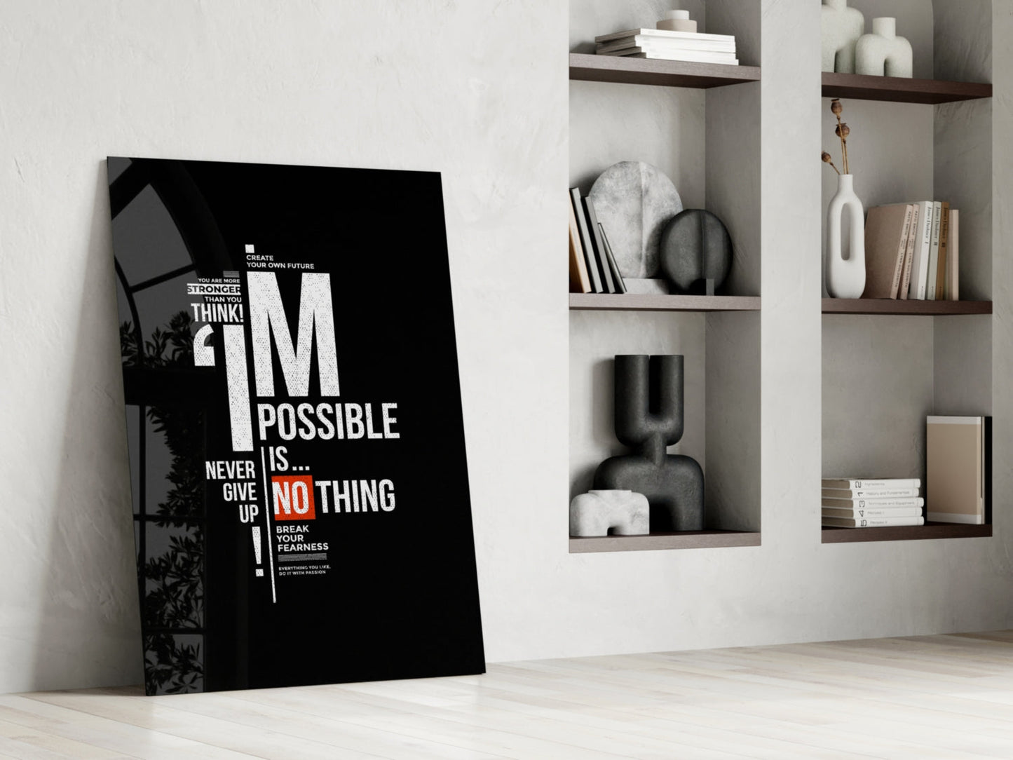 Black motivational glass wall art leaning against white wall beside shelving unit displaying decorative items and books.