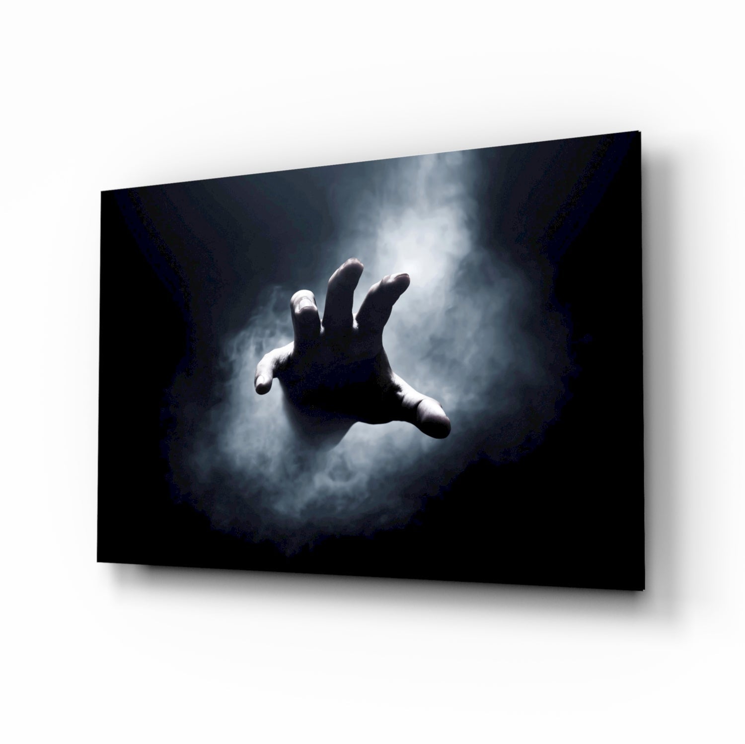 Glass wall art panel displaying a reaching hand silhouetted against dramatic stormy clouds on dark background.