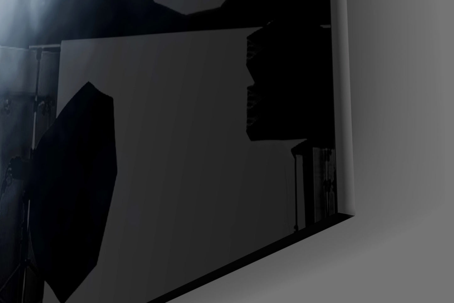 Black silhouette fear glass wall art mounted on white wall, backlit with dramatic shadow effect.
