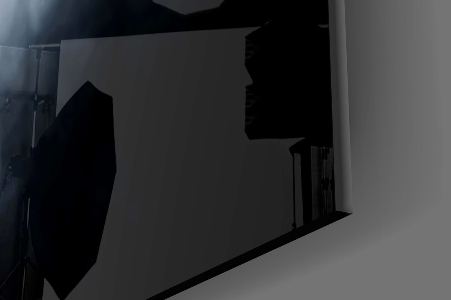 Black silhouette fear glass wall art mounted on white wall, backlit with dramatic shadow effect.
