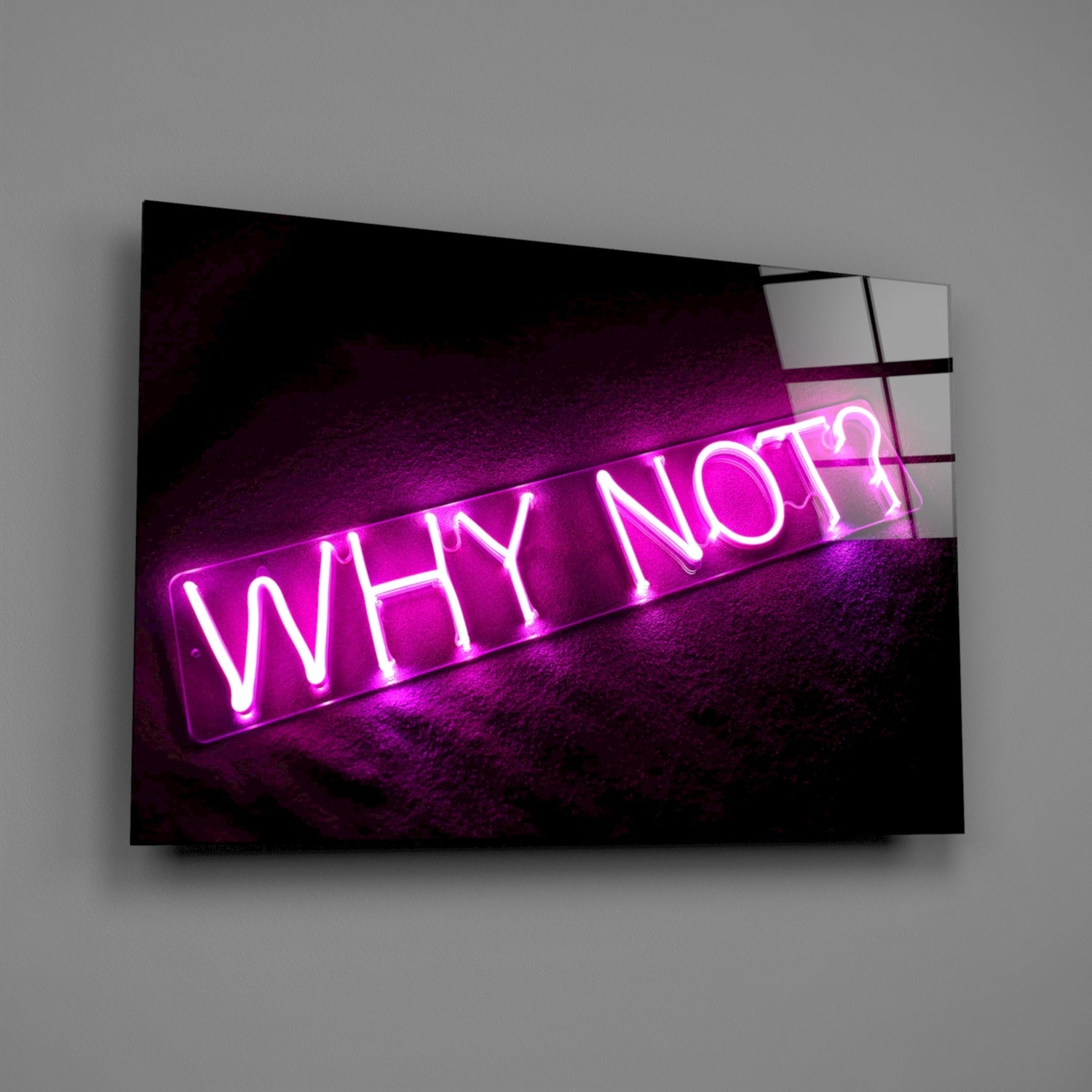 Magenta neon "Why Not?" sign mounted on dark textured wall behind angled glass panel, photographed at three-quarter view.