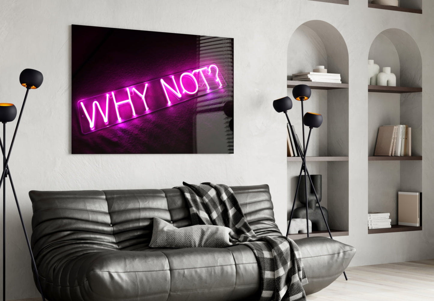 Magenta neon "WHY NOT?" glass wall art displayed above black leather sofa in modern living room with shelving.