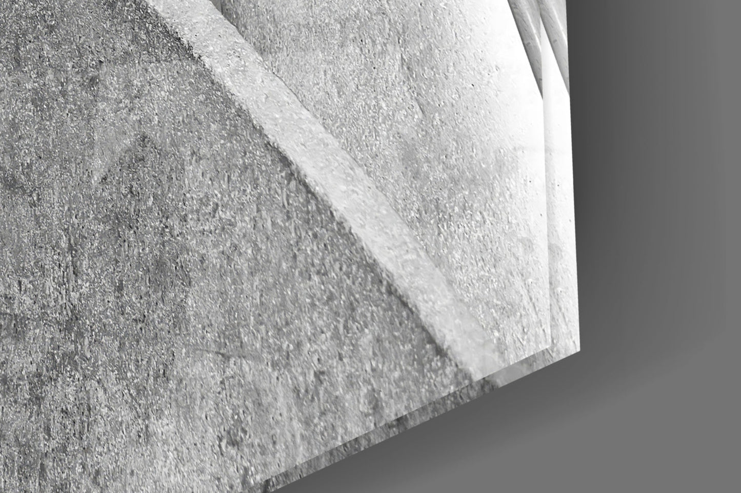 Close-up detail of textured concrete surface with white glass edge, showing material layering and dimensional depth.