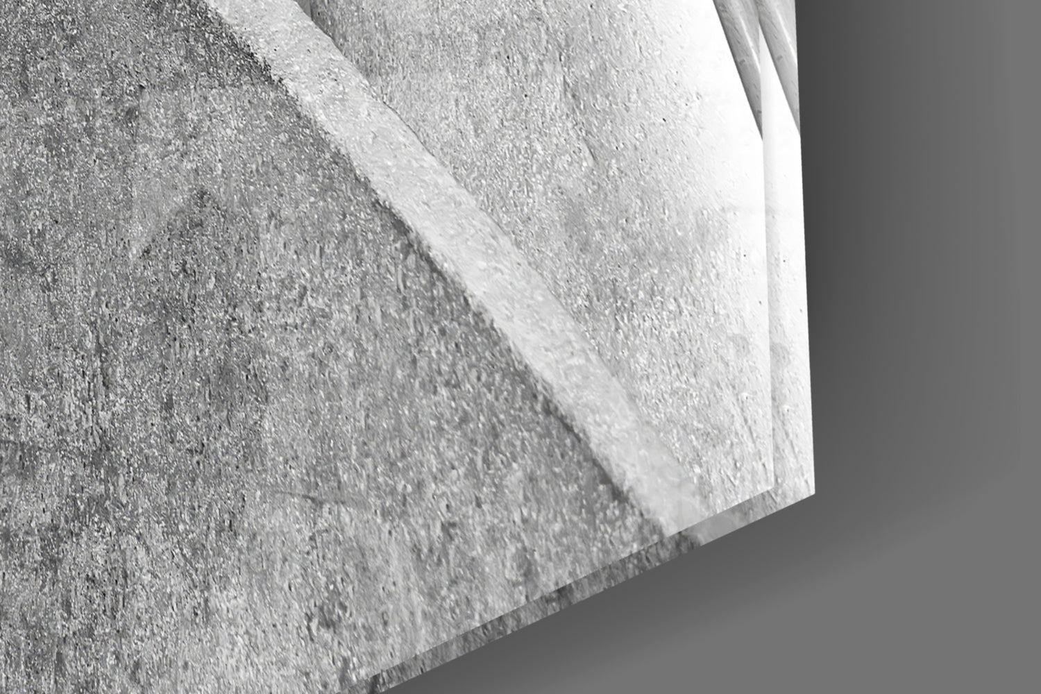Close-up detail of textured concrete surface with white glass edge, showing material layering and dimensional depth.