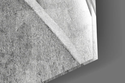 Close-up detail of textured concrete surface with white glass edge, showing material layering and dimensional depth.