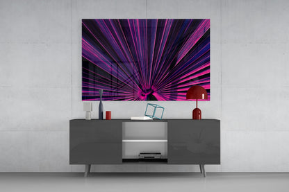 Vibrant magenta and purple radial burst glass wall art displayed above a modern gray media console with decorative accessories.