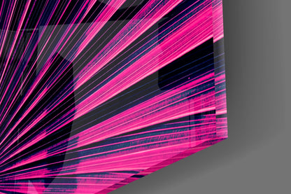 Close-up of neon pink and blue glass art with radiating linear streaks and black geometric shapes against gray background.