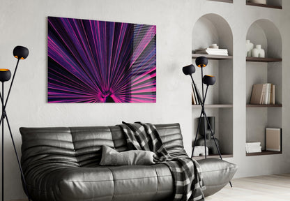 Modern living room with black leather sofa displaying vibrant pink and purple radial burst glass wall art above it.