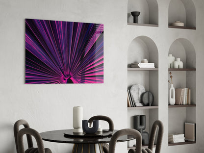 Vibrant purple and pink radial burst glass art panel hung above a modern dining room with round table and curved chairs.