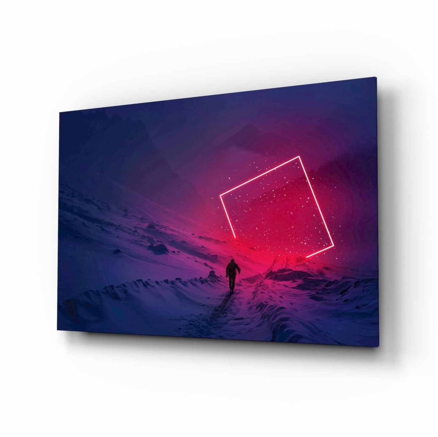 Glass wall art panel displayed at angle showing silhouetted figure in snowy landscape beneath neon pink rectangle against blue-purple gradient sky.