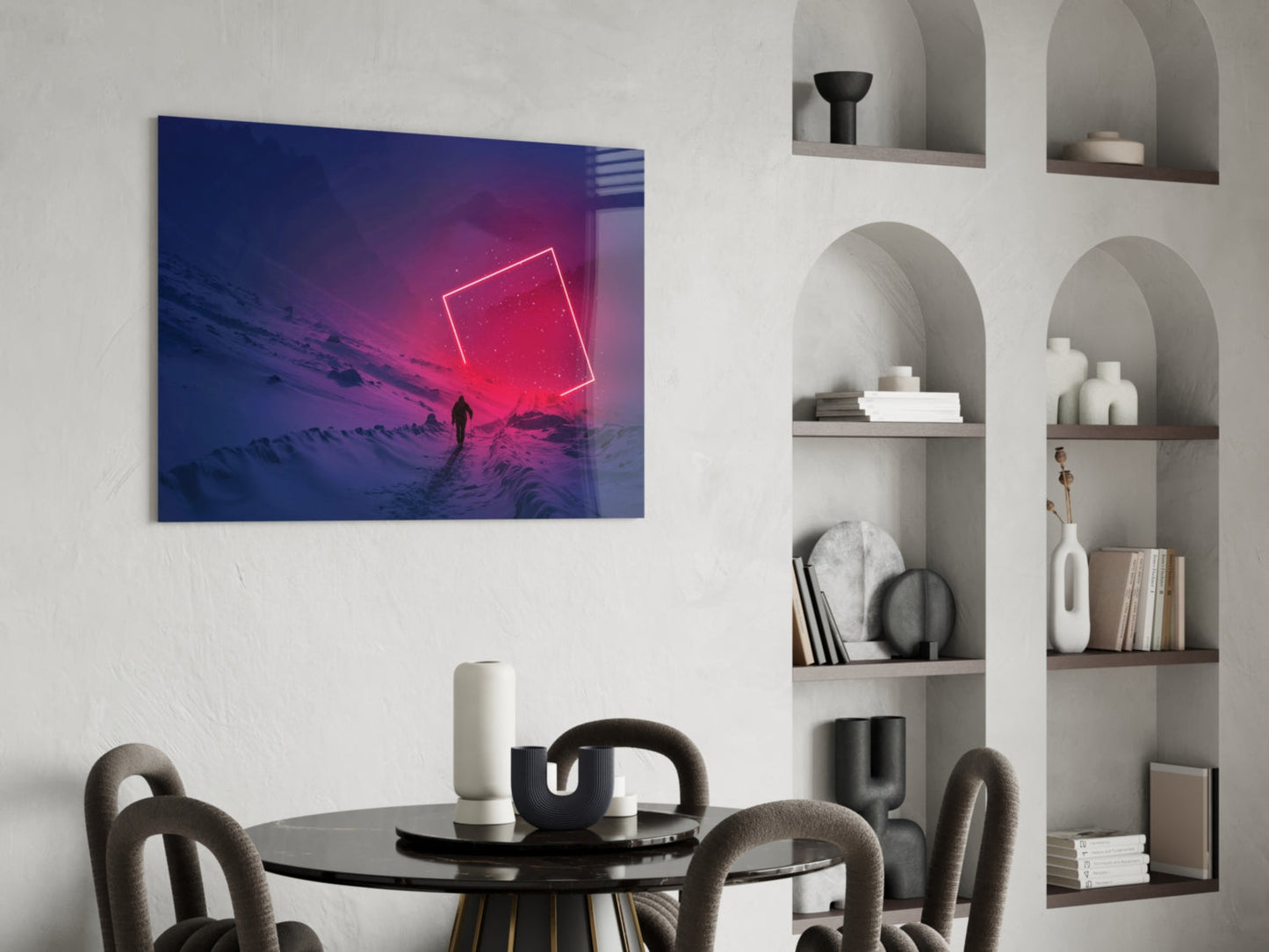 Modern dining room with neon pink geometric shape glass wall art above round black table and curved chairs, beside white arched shelving unit.