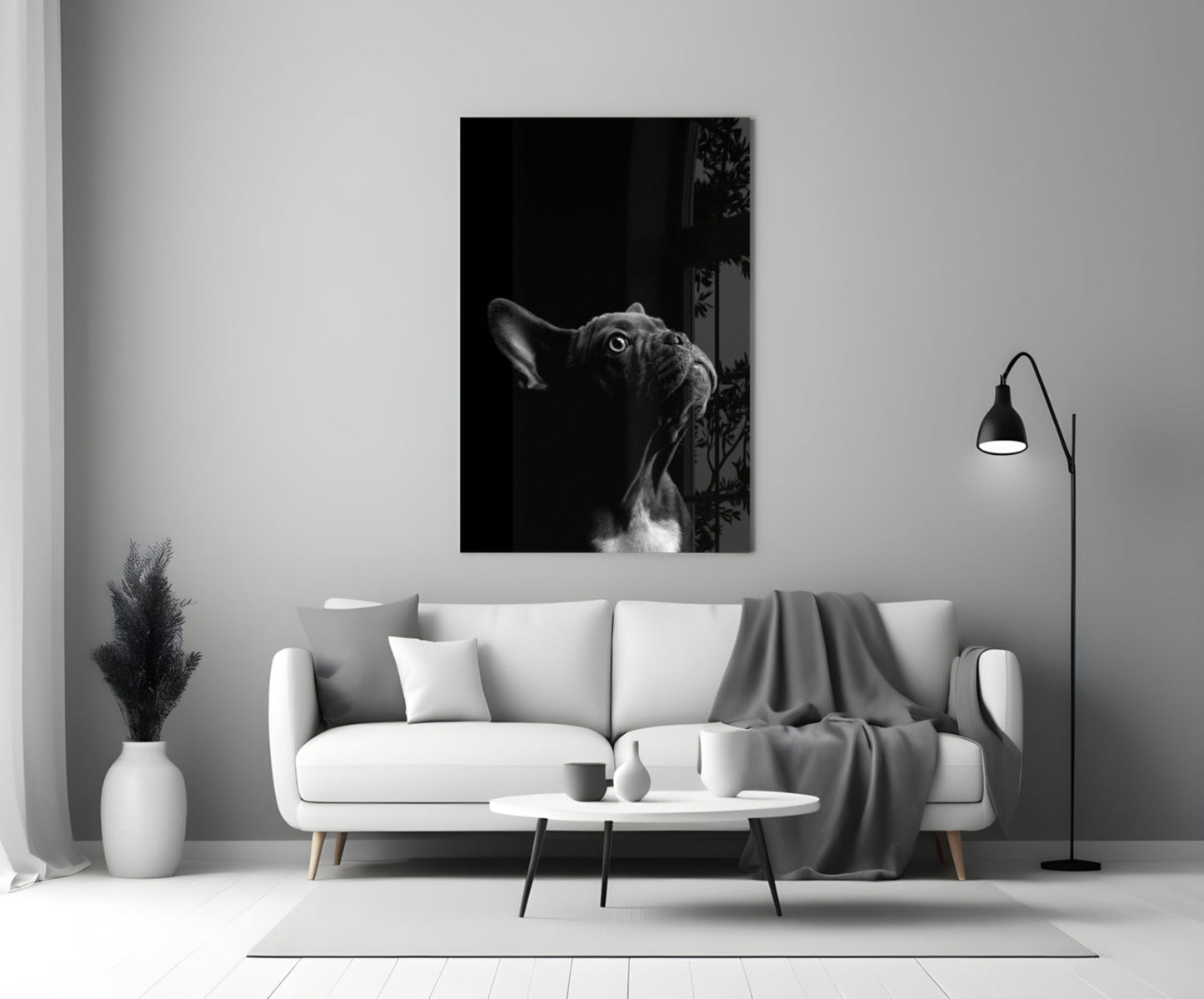 Black and white French Bulldog glass wall art displayed above a white sofa in a minimalist living room setting.