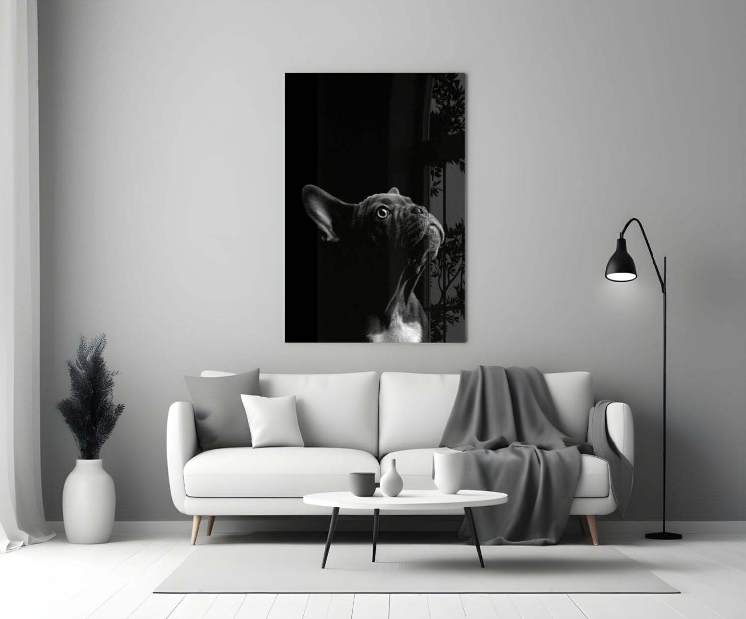 Black and white French Bulldog glass wall art displayed above a white sofa in a minimalist living room setting.