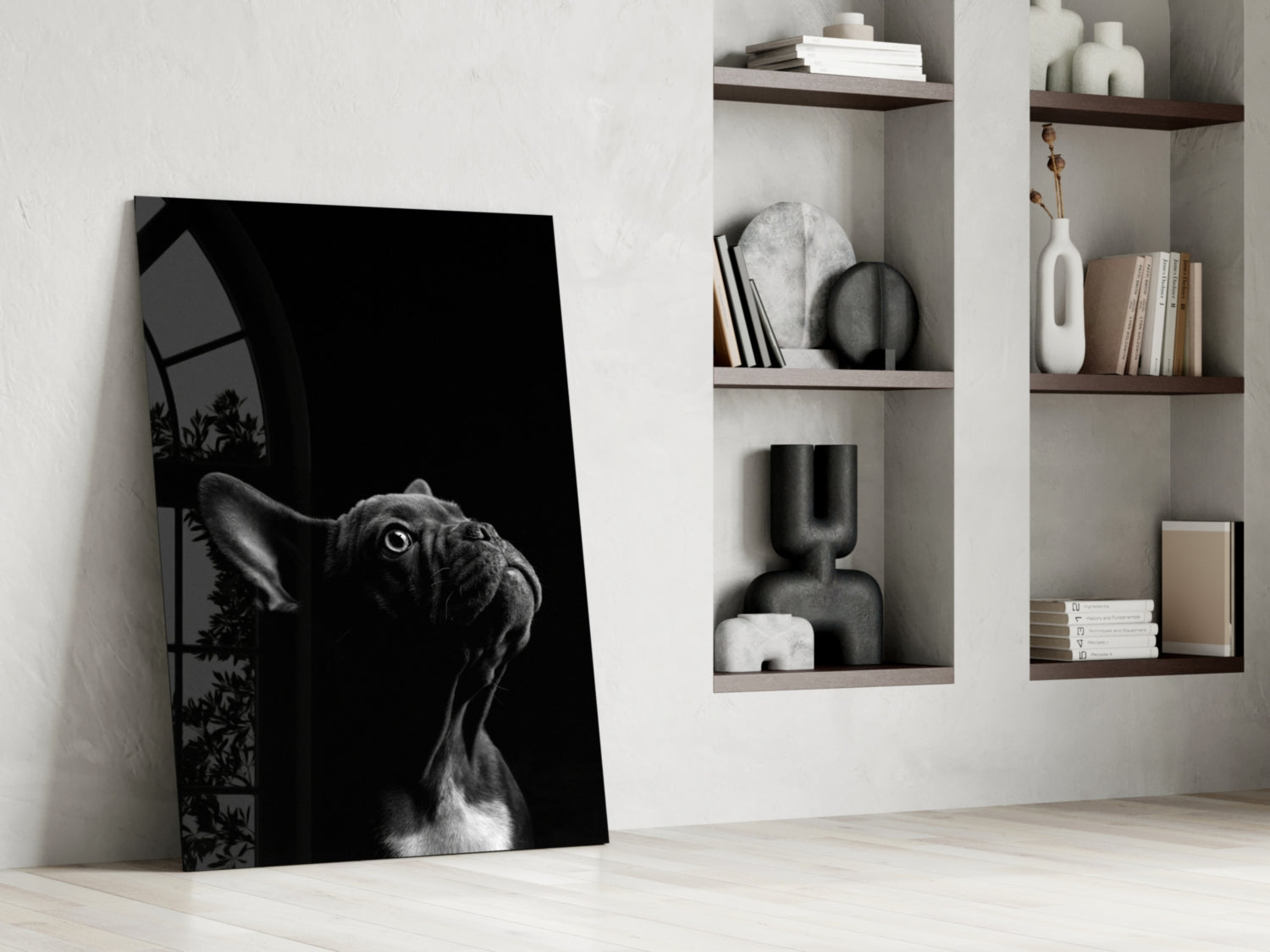 Black and white glass wall art of a bulldog's head leaning against white shelving with decorative items.