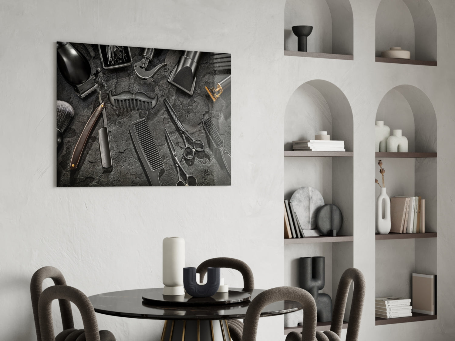 Black and white glass wall art depicting overhead barbering tools arranged on textured surface, displayed above round dining table in modern interior.