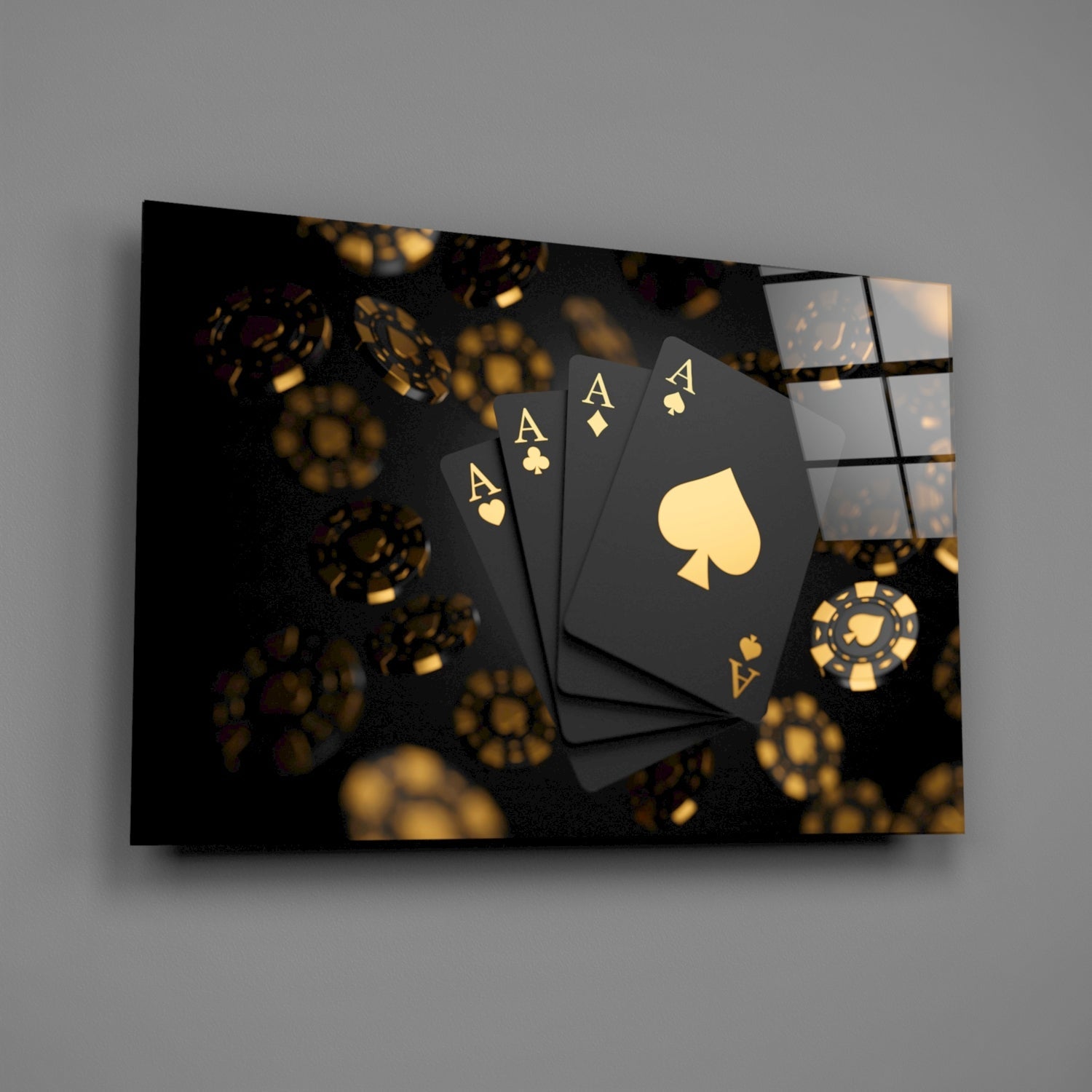 Black glass wall art displaying four gold aces and poker chips against dark background, angled perspective view.