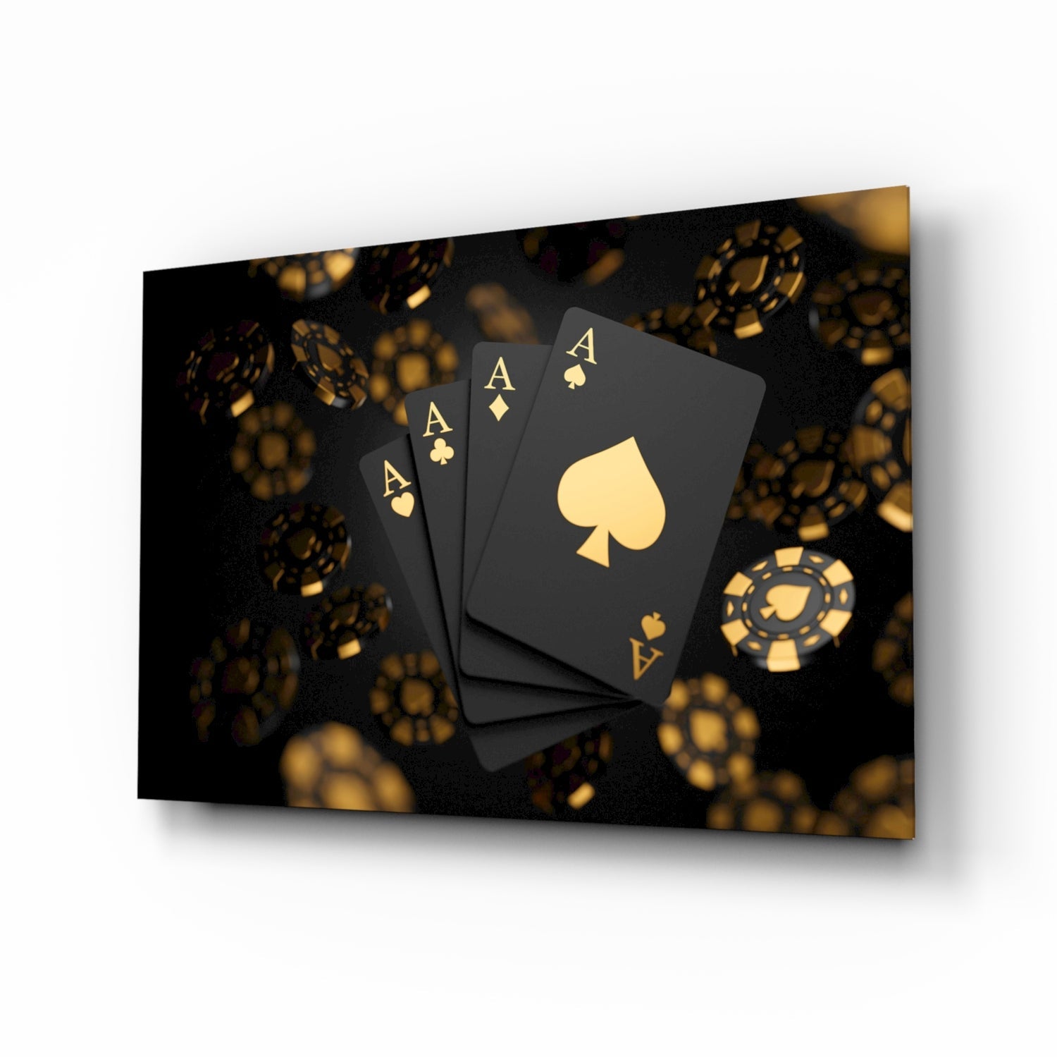 Four black playing cards with gold aces and suit symbols arranged on dark background with blurred gold casino chips.