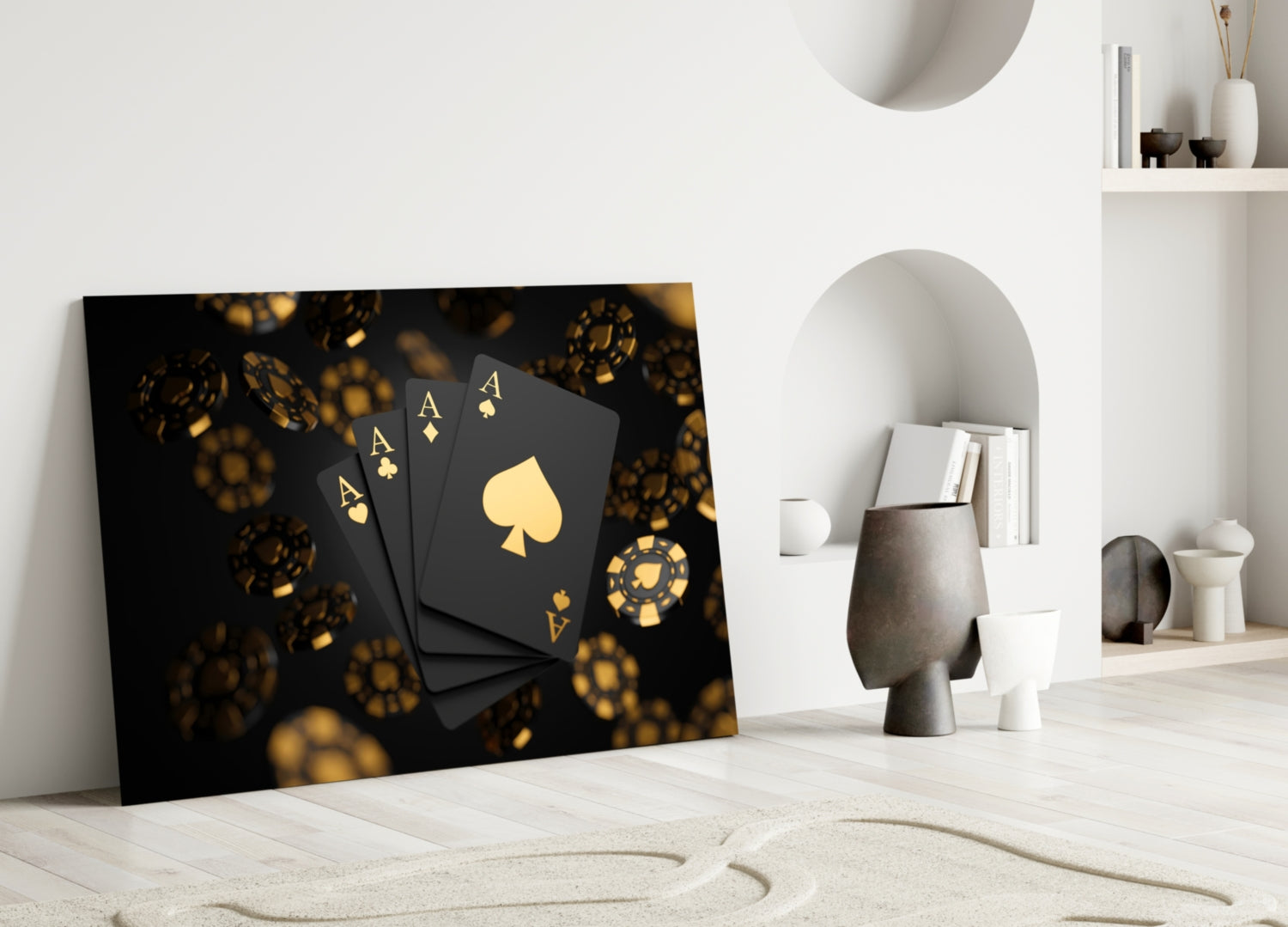 Black glass wall art with gold playing cards and casino chips leaning against white interior wall shelving.