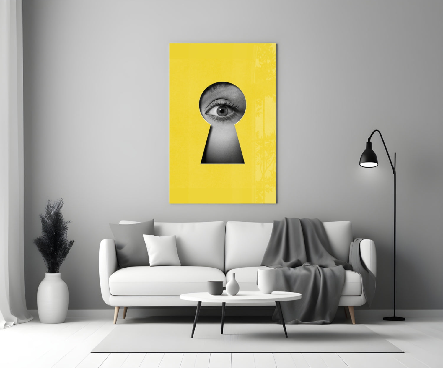 Yellow glass wall art with black keyhole cutout and eye illustration, displayed above white sofa in modern living room.