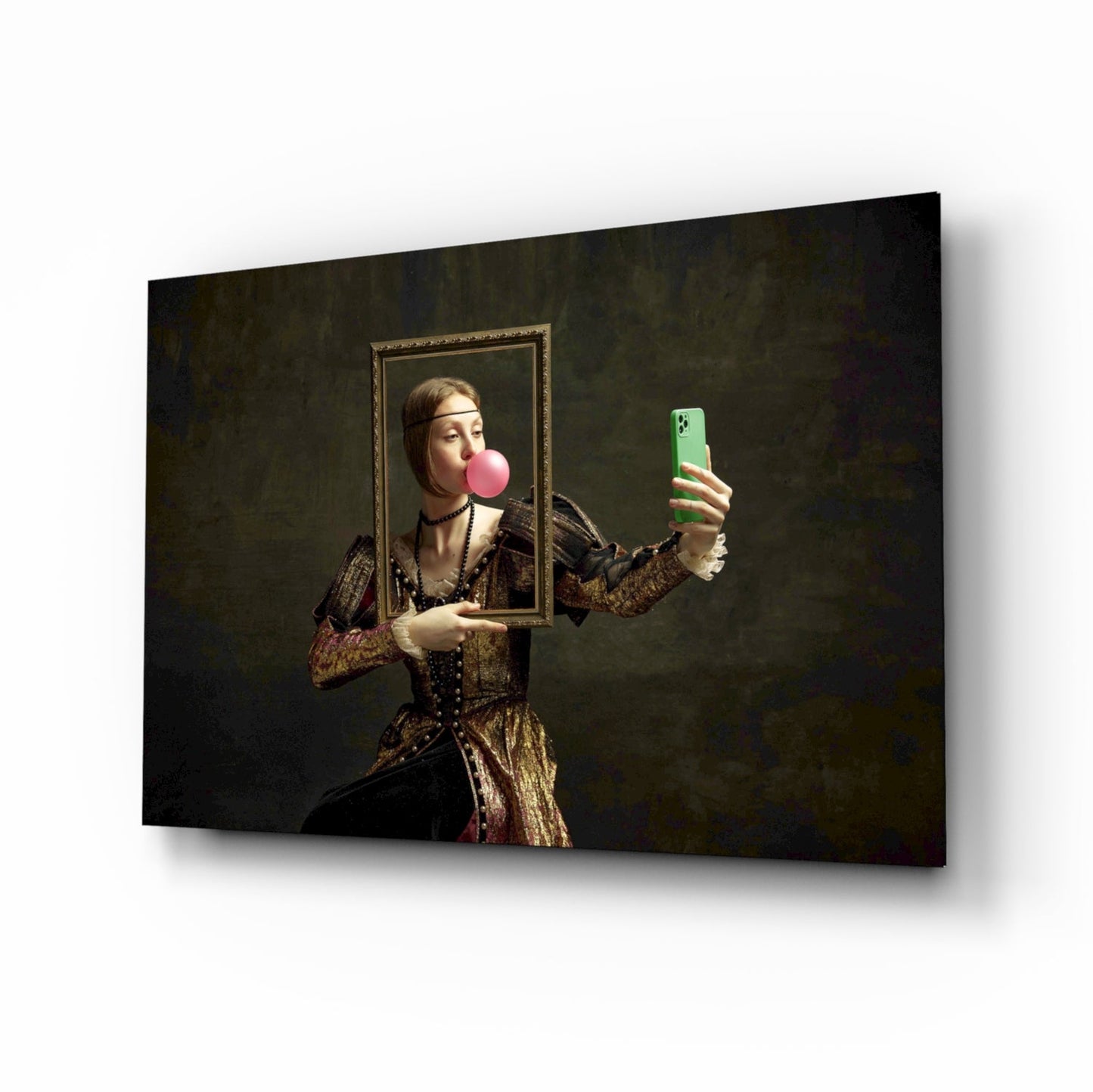 Renaissance-dressed figure holding ornate frame and green phone, blowing pink bubble, against dark textured background on glass panel.