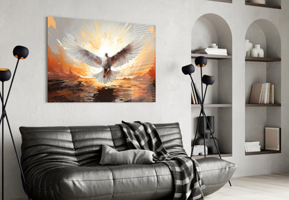 Glass wall art depicting a white and brown dove ascending against an orange and gold sky, displayed above a black leather sofa in a modern living room.