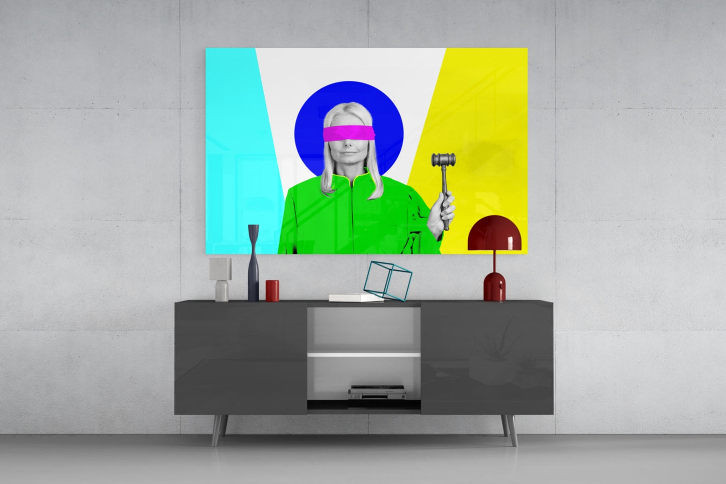 Colorful glass wall art mounted above dark media console displays pop art portrait with magenta blindfold and bright cyan, yellow, and blue background.