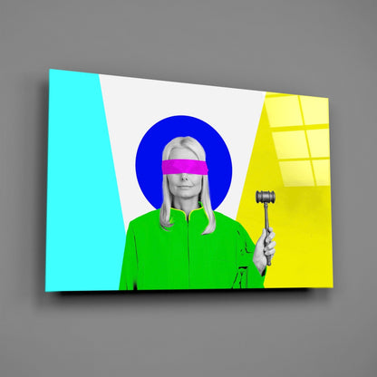 Angled view of colorful glass wall art featuring a woman in green jacket with magenta eye band and gavel, set against cyan, blue, yellow, and white geometric background.