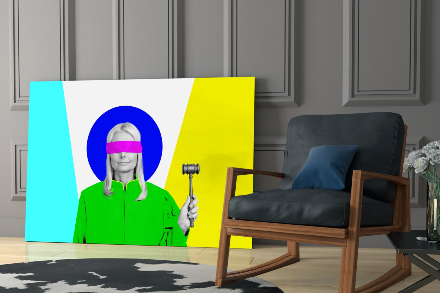 Colorful glass wall art featuring a woman in green jacket with pink blindfold and blue circular halo, holding gavel, displayed in modern living room with wooden chair.