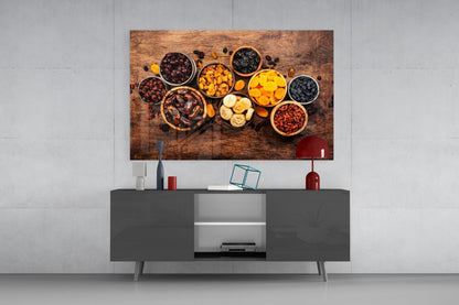 Modern living room setup featuring nuts and dried fruits wall art above a dark gray media console with decorative accessories.